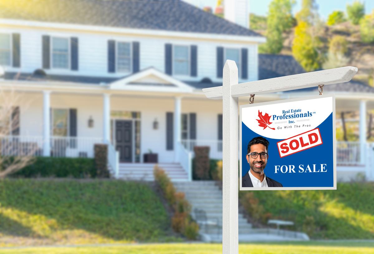 Real Estate Professionals sold sign in front of a house